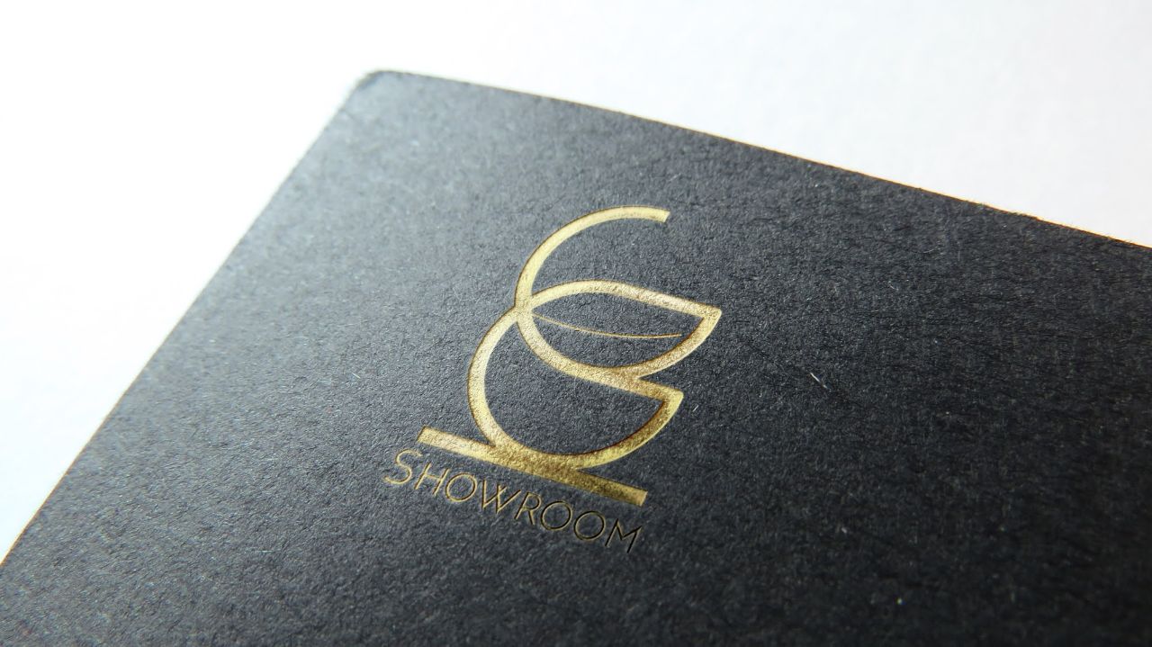 Showroom logo, gold foil stamped on black stock