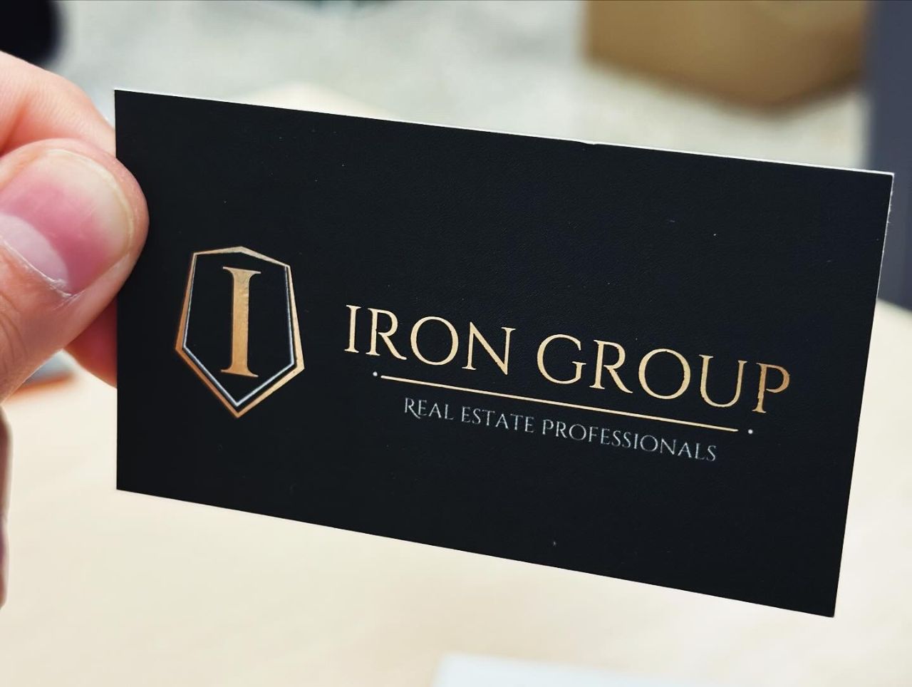 Iron Group business card, gold foil on soft-touch black